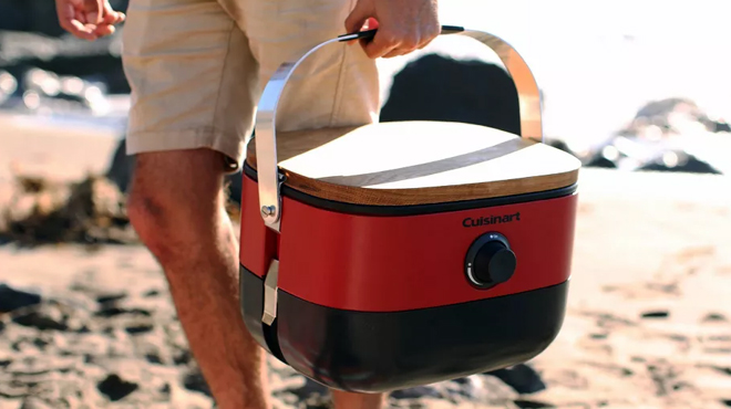 A Person Carrying a Cuisinart 1 Burner Portable Gas Grill