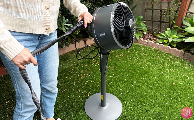 A Person Connecting a Fan in a Yard