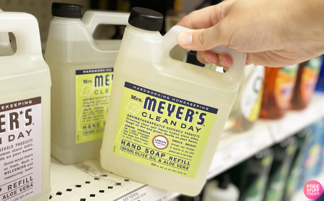 A Person Getting a Mrs Meyers Clean Day Liquid Hand Soap Refill from the Shelf