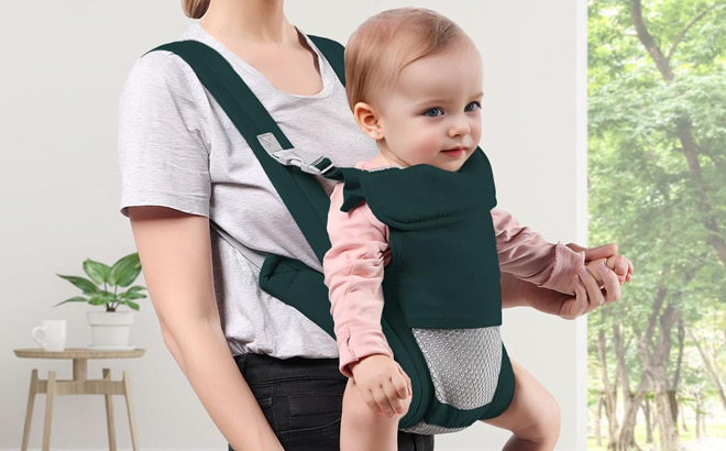 A Person Holding Baby in Baby Carrier Newborn to Toddler