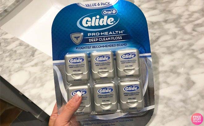 A Person Holding Oral B Dental Floss 6 Pack