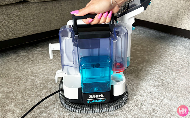 A Person Holding Shark Carpet Cleaner