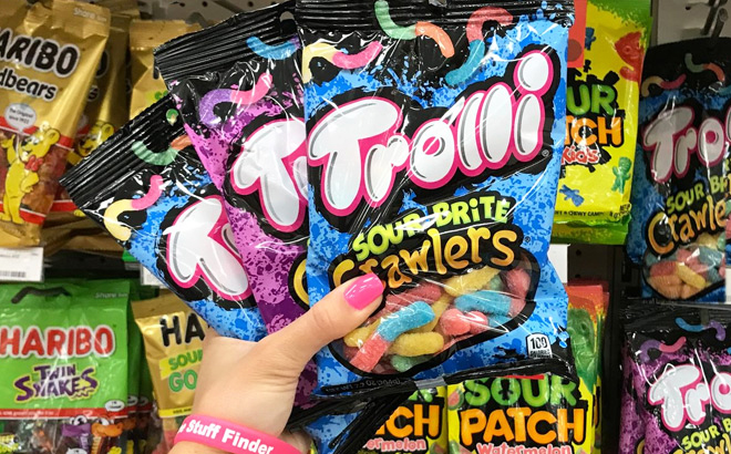 A Person Holding Three Packs of Trolli Sour Brite Crawlers