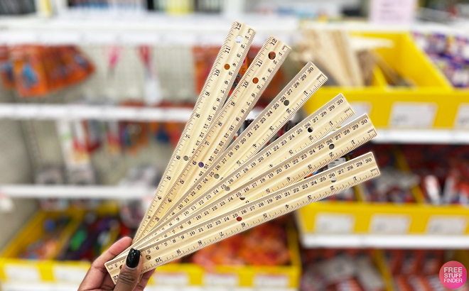 A Person Holding Up and Up Rulers