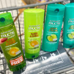 A Person Holding a Garnier Fructis Shampoo with Other Products in the Cart at Walgreens