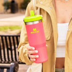 A Person Holding a Stanley The Heat Wave IceFlow Flip Straw 30 Ounce Tumbler