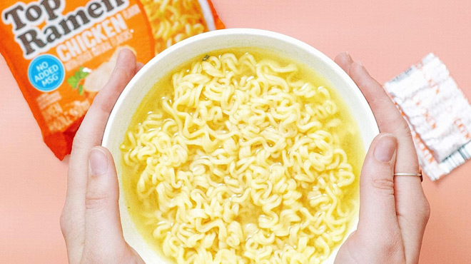 A Person Holding a bowl of Nissin Instant Ramen Noodle Soup