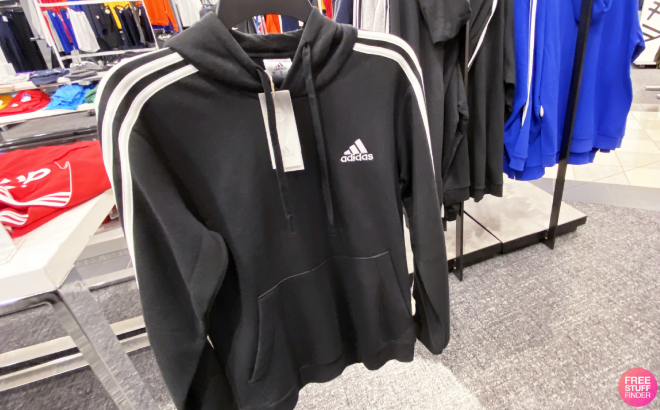 A Person Holding an Adidas Mens Essentials Fleece 3 Stripes Hoodie