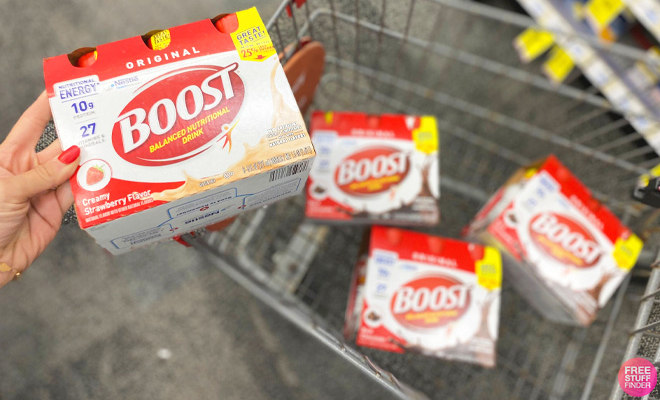 A Person Holding the Boost Original Nutritional Drink in the Flavor Creamy Strawberry 6 Count at CVS