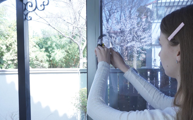 A Person Installing a Magidekor One Way Window Privacy Film