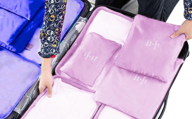 A Person Organizing Her Travel Packing Cubes