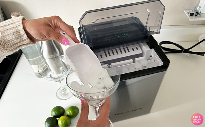 A Person Putting Ice in a Glass from an Ice Maker