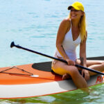A Person Sitting on FunWater Inflatable Stand Up Paddle Board