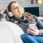 A Person Smiling and Listening Podcast