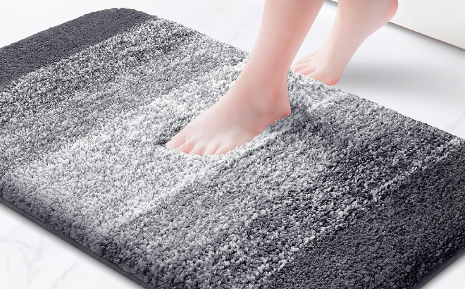 A Person Stepping on a Kmat Bathroom Rug