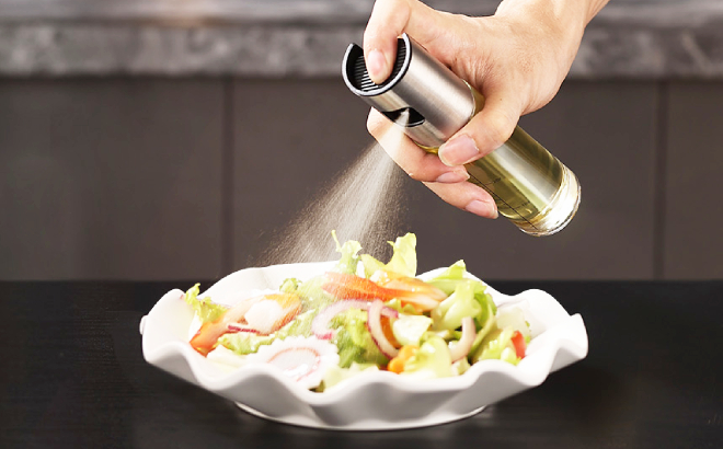 A Person Using an Oil Sprayer for Her Salad