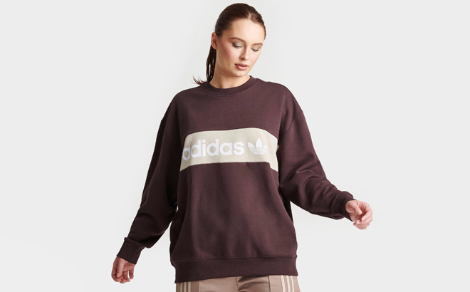 A Person Wearing Adidas Originals Womens Crewneck Sweatshirt
