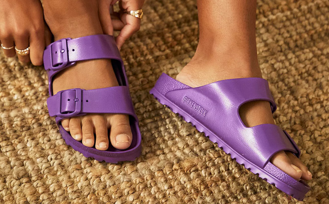 A Person Wearing Birkenstock Arizona Eva Sandals in Violet Color