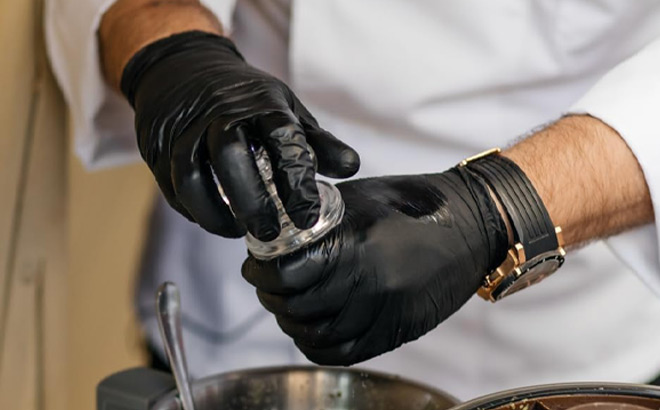 A Person Wearing Black Nitrile Gloves