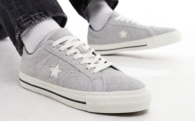 A Person Wearing Converse One Star Pro Shoes in Gray Color