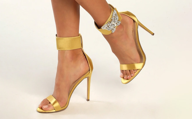 A Person Wearing Lulus Mariahh Pear Satin Rhinestone Butterfly Ankle Strap Heels