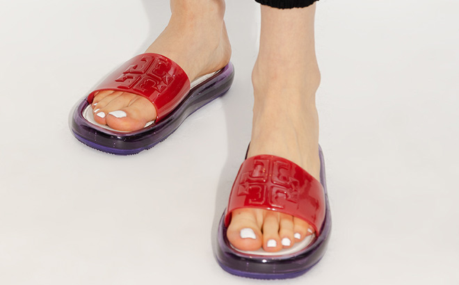 A Person Wearing Torry Burch Bubble Jelly Slides