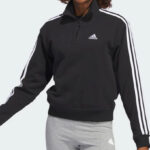 A Person Wearing the Womens Essentials 3 Stripes Quarter Zip Sweatshirt in Black