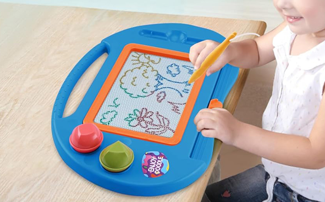 A Person drawing on a Magnetic Drawing Board