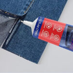A Person gluing their Jeans with Permanent Fabric Glue 1
