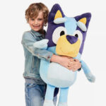 A Person holding a 36 Inch Bluey Plush