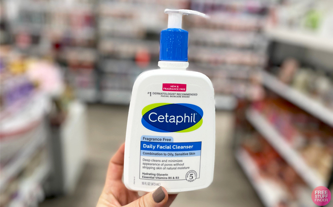A Person holding a Bottle of Cetaphil 16 oz Daily Facial Cleanser