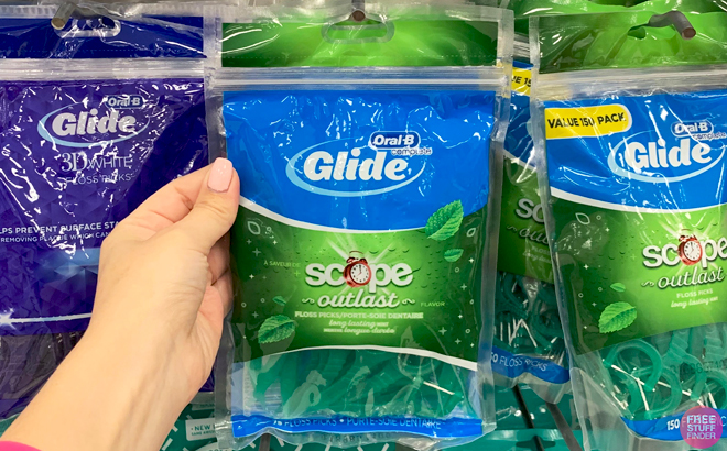 A Person holding a Pack of 75 Count Oral B Glide Floss Picks