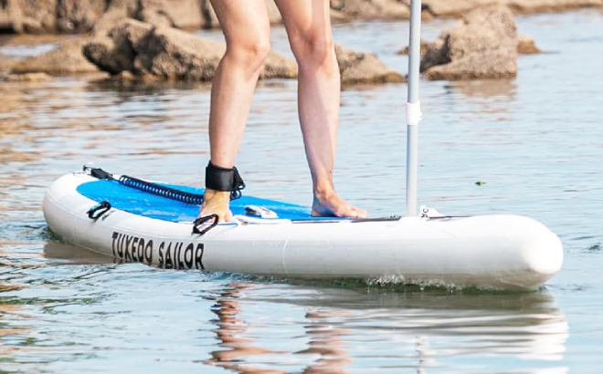 A Person on a Tuxedo Sailor Inflatable Stand Up Paddle Board