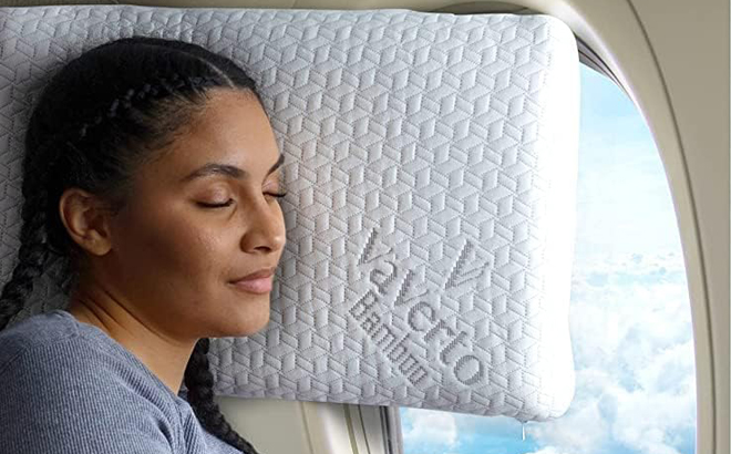 A Person sleeping on Vaverto Memory Foam Pillow on a Plane