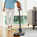 A Person using Shark Pet Corded Stick Vacuum