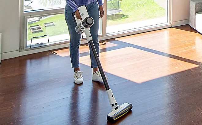 A Woman Cleaning Wooden Floor with the Karcher VCN 3 Cordless Stick Vacuum