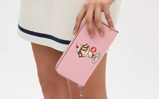 A Woman Holding Coach Outlet Long Zip Around Wallet With Sundae Graphic