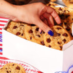 A Woman Holding Tiff’s Treats Chocolate Chip Cookies