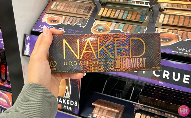 A Woman Holding Urban Decay Naked Wild West Eyeshadow Palette