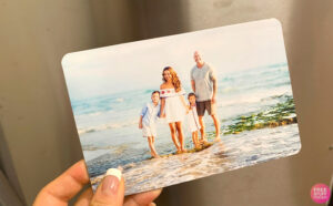 A Woman Holding a 5x7 Photo Magnet