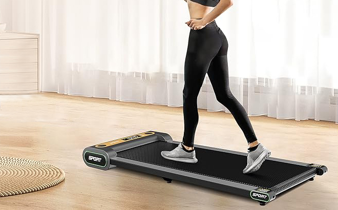 A Woman Using an Under Desk Walking Pad