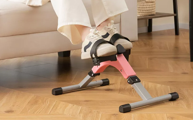 A Woman Using the Costway Under Desk Exercise Bike