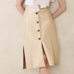A Woman Wearing Banana Republic Factory Seamed Vegan Leather Midi Skirt in Oyster Pearl