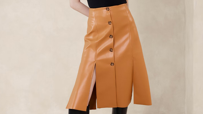 A Woman Wearing Banana Republic Factory Seamed Vegan Leather Midi Skirt in Tan