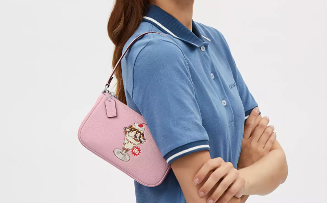 A Woman Wearing Coach Outlet Nolita 19 Bag With Sundae Graphic
