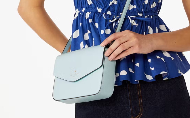 A Woman Wearing Kate Spade Sadie Envelope Crossbody Bag