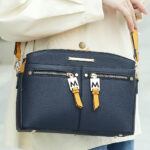 A Woman Wearing MKF Collection Zoely Crossbody Bag