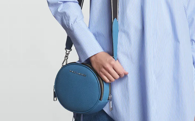 A Woman Wearing Marc Jacobs The Rewind Crossbody Bag