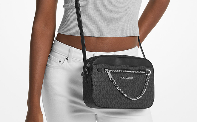 A Woman Wearing Michael Kors Jet Set Large Logo Crossbody Bag in Black