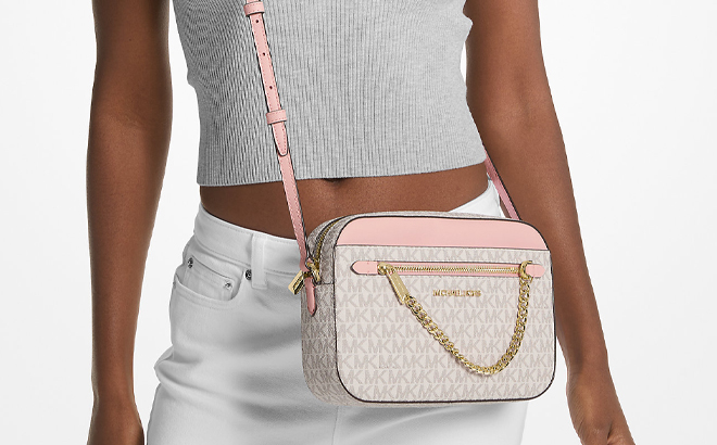 A Woman Wearing Michael Kors Jet Set Large Logo Crossbody Bag